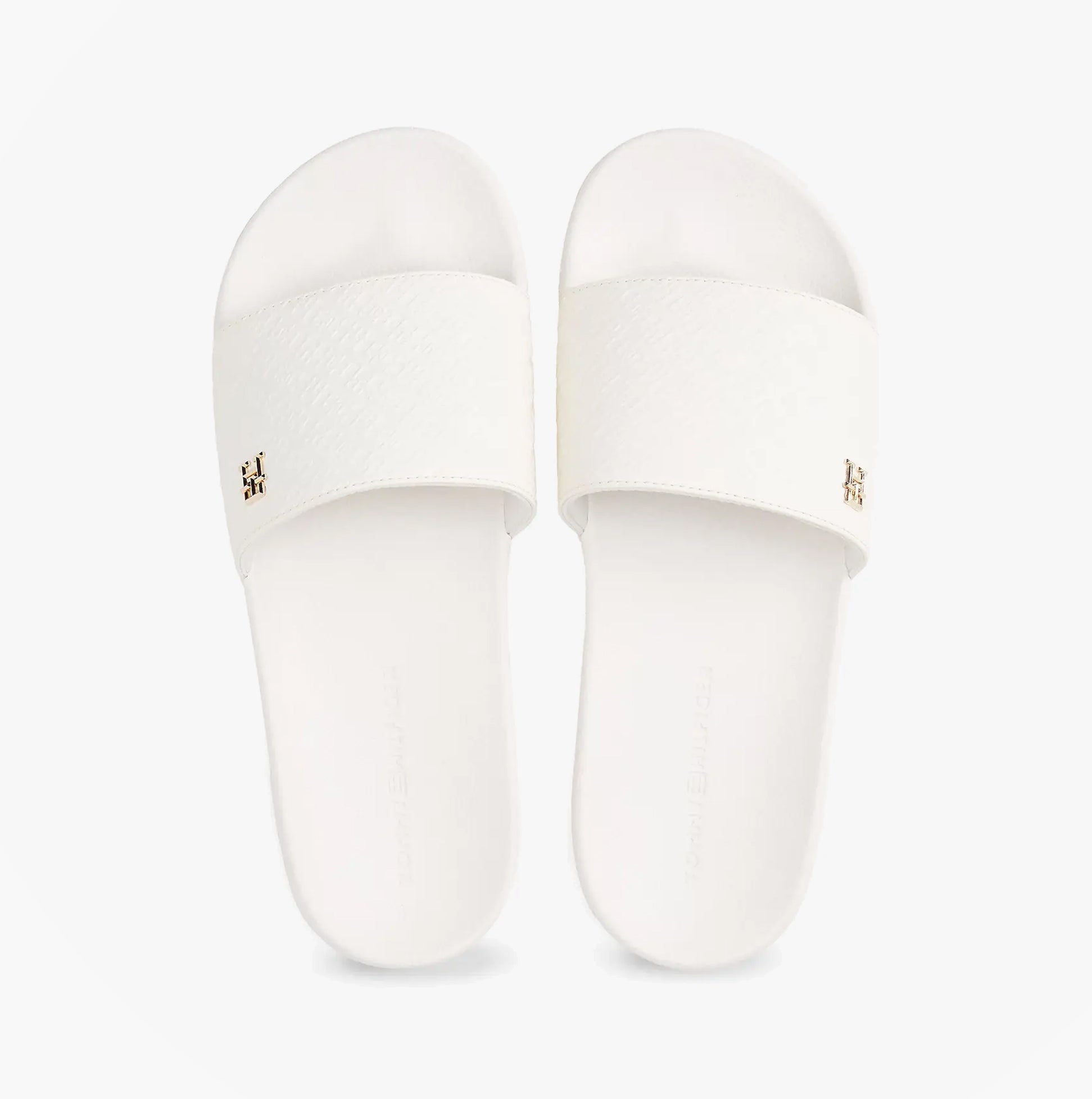 Tommy Hilfiger MONOGRAM POOLSIDE Womens Sliders White top view with embossed TH monogram and gold plaque.