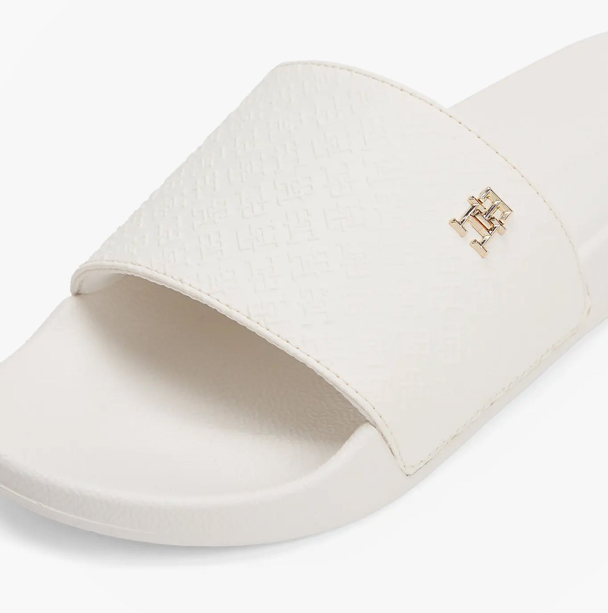 Tommy Hilfiger MONOGRAM POOLSIDE Womens Sliders White side view showing embossed TH monogram and plaque details.