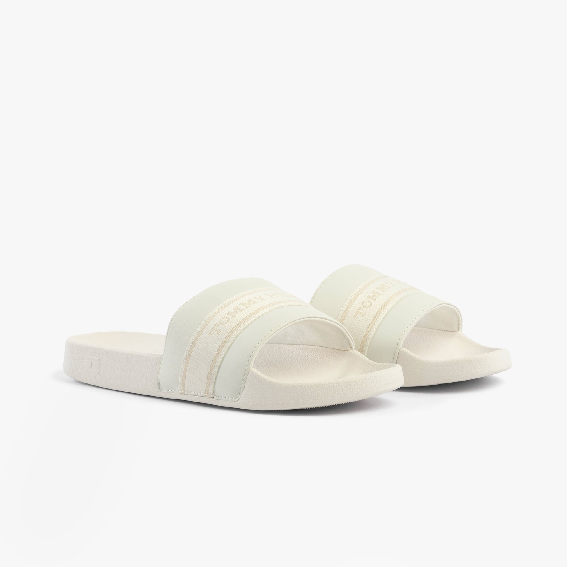Tommy Hilfiger LOGO WEBBING Womens Slides Ecru side view showcasing the soft polyurethane upper and flat EVA sole.