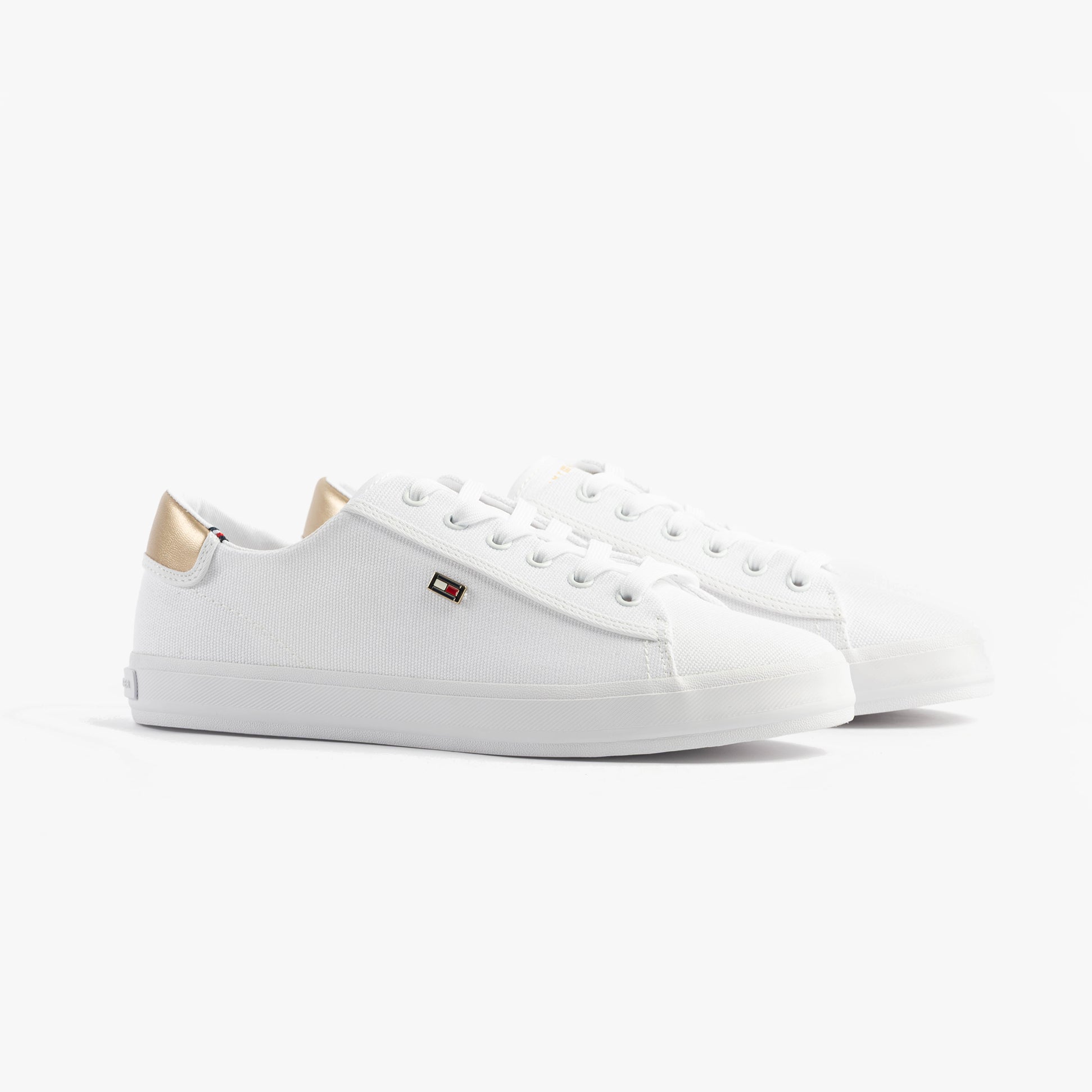 Tommy Hilfiger CANVAS METALLIC HEEL Womens Trainers White side view showcasing canvas upper and metallic heel.