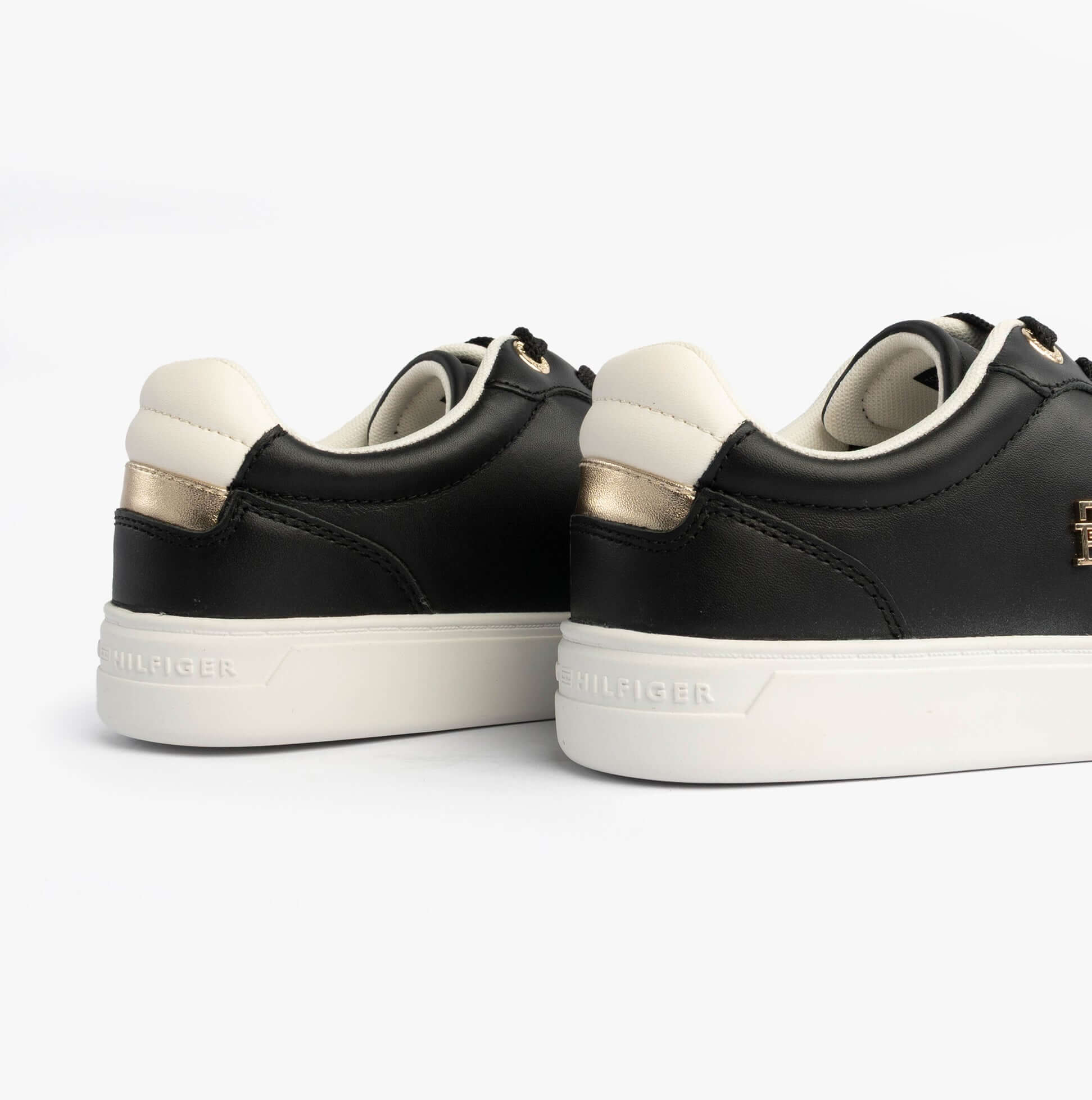 Tommy Hilfiger Womens Leather TH Monogram Plaque Court Trainers Black back view showcasing sleek design and color contrast.