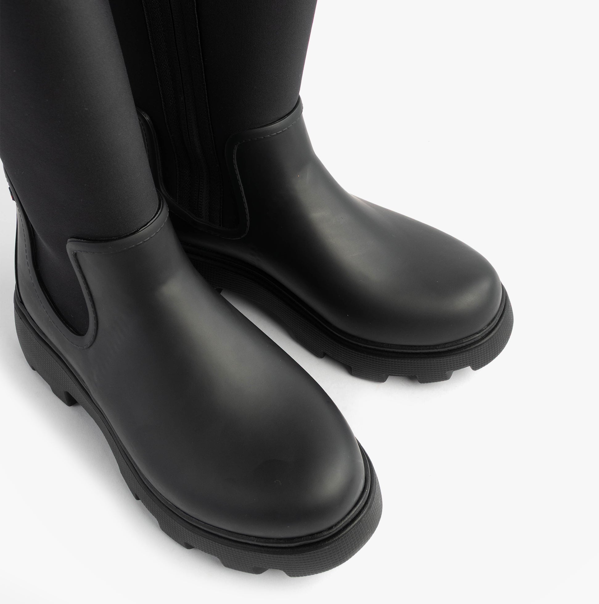 Tommy Hilfiger FLAG LONG RAINBOOT Womens Boots Black top view showcasing smooth rubber finish and comfortable design.