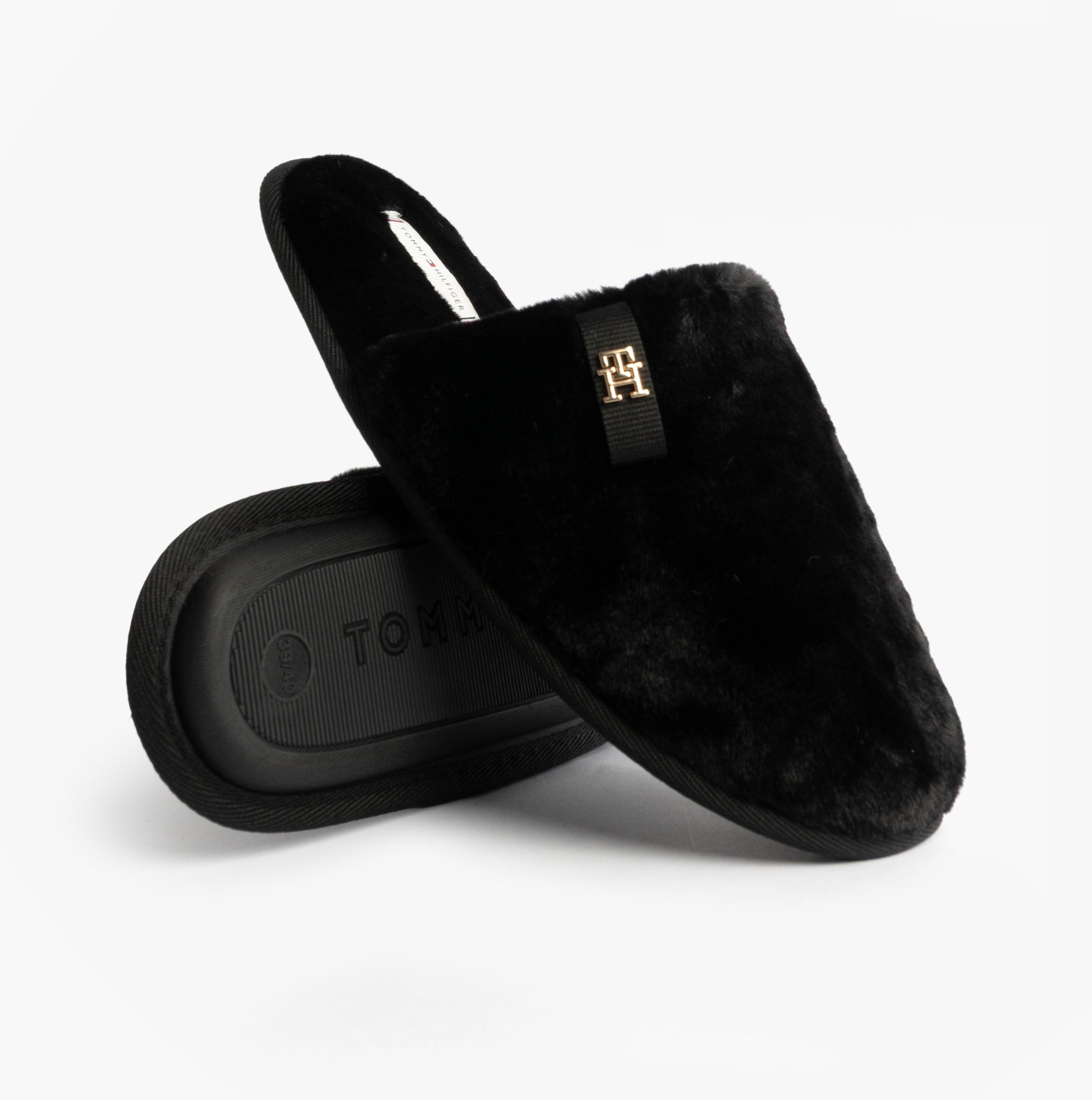 Tommy Hilfiger TH FAUX FUR HOUSE SH Womens Slippers Black side view with fluffy texture and logo detail.