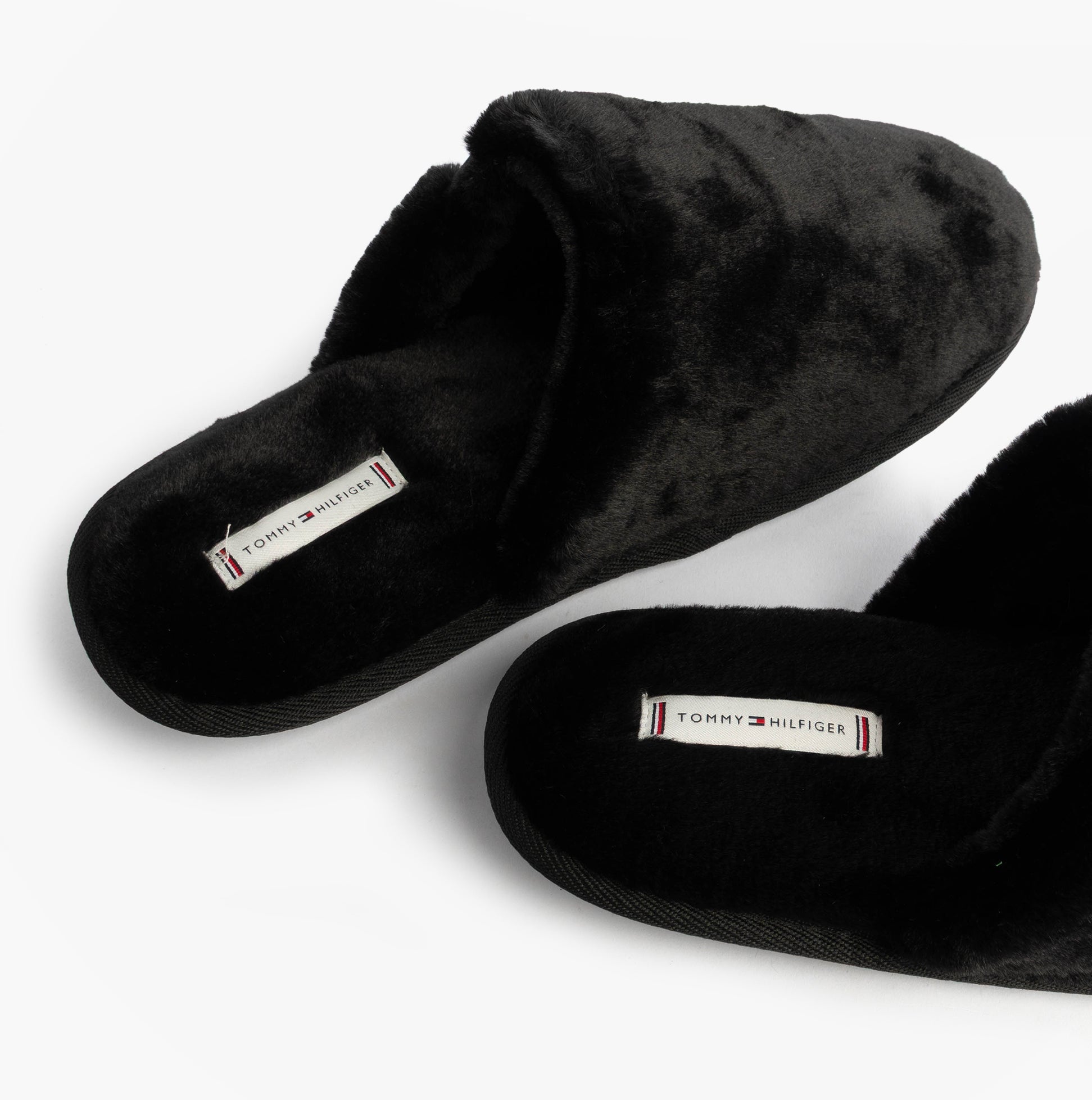 Tommy Hilfiger TH FAUX FUR HOUSE SH Womens Slippers Black top view showcasing soft faux fur and slip-on design.