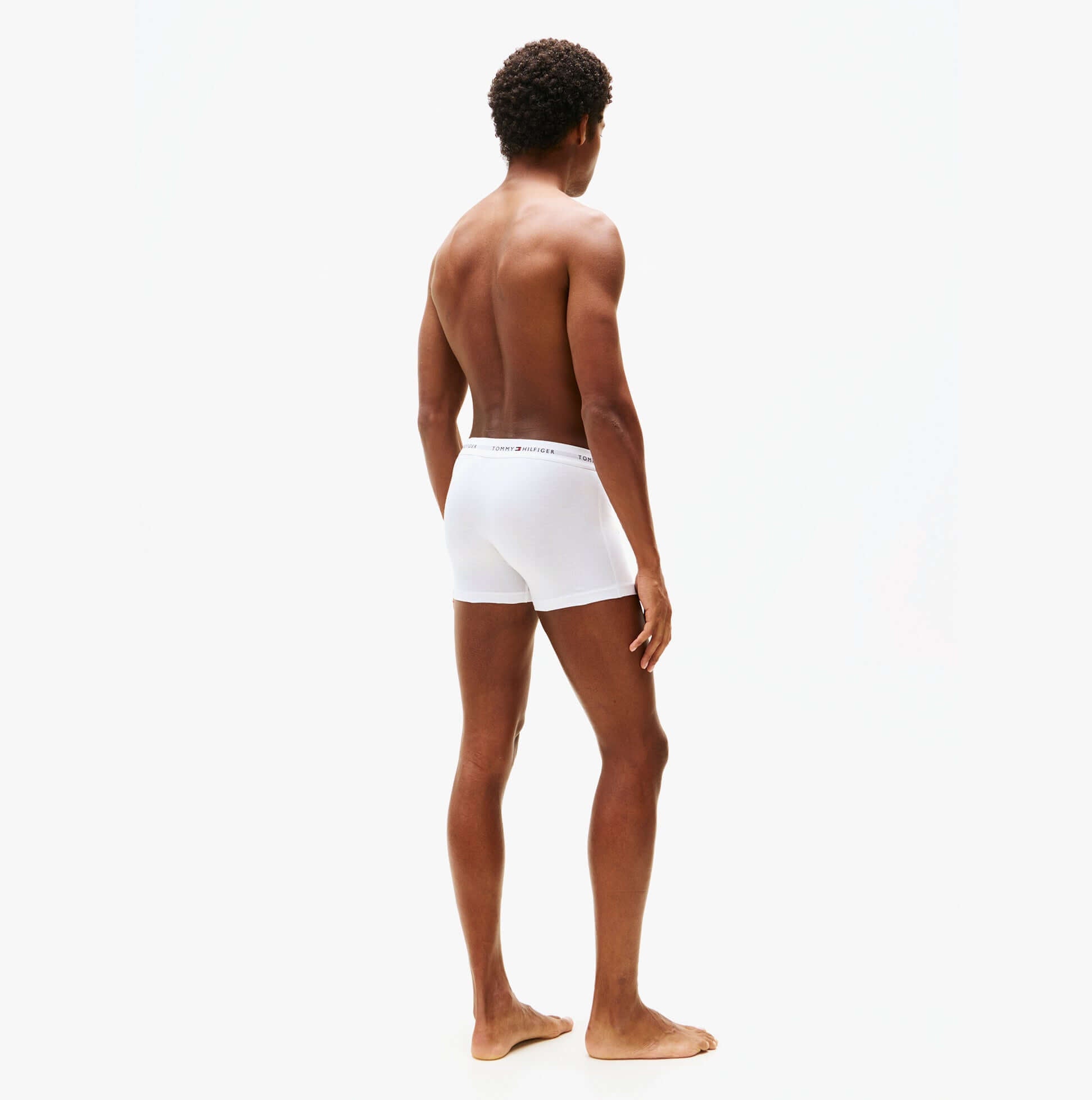 Tommy Hilfiger 3 Pack Trunk Mens White back view on model, showcasing fit and elastic waistband.