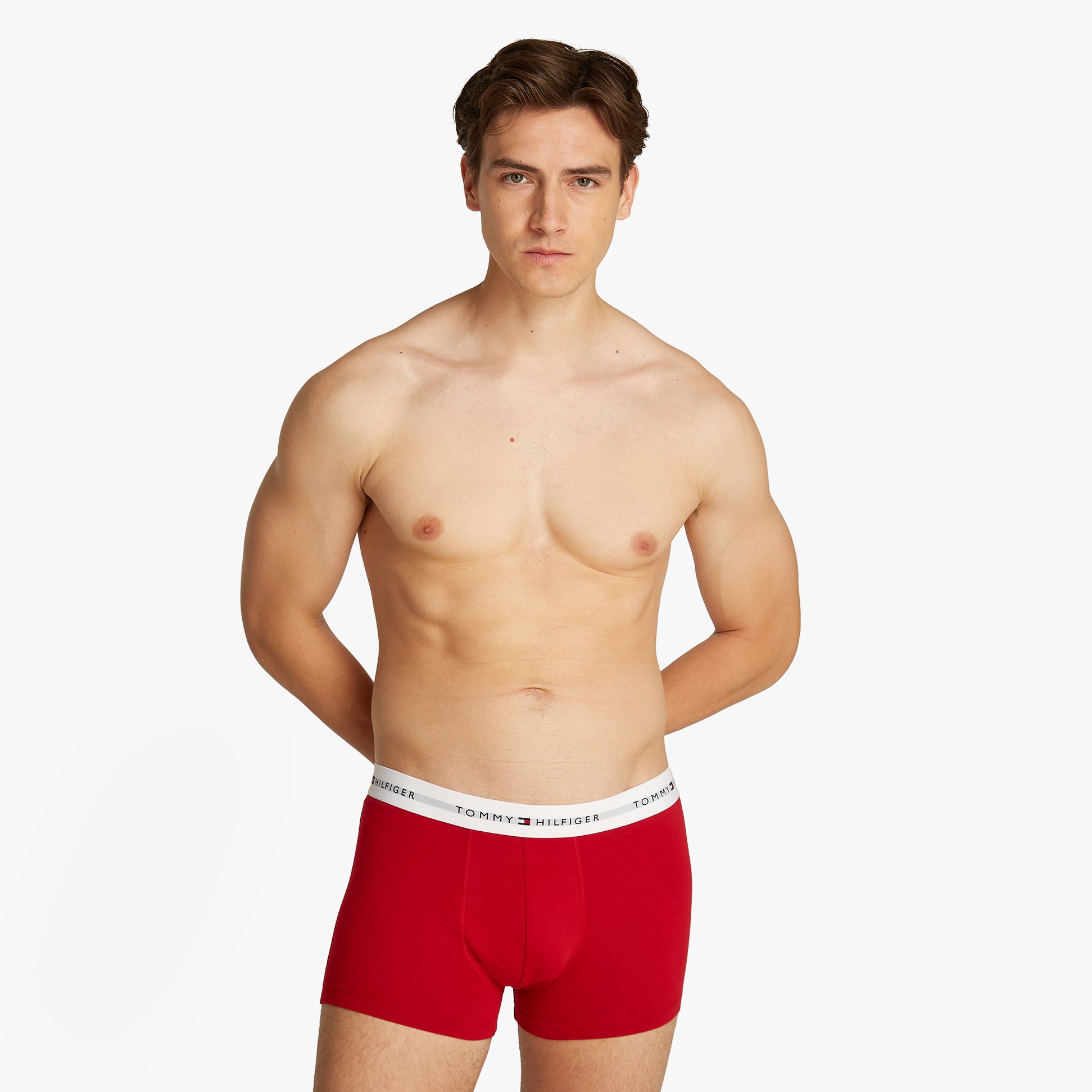 Tommy Hilfiger 3 Pack Mens Logo Waistband Trunks Multicoloured front view on model wearing red trunks with logo waistband.