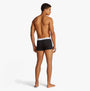 Tommy Hilfiger 3 Pack Mens Colour-Blocked Logo Trunks Black back view on model, showcasing elasticated waistband and trunk design.