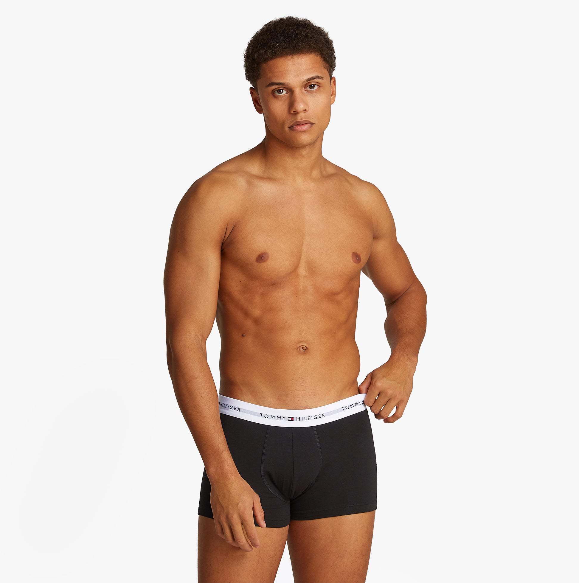 Tommy Hilfiger 3 Pack Mens Colour-Blocked Logo Trunks Black front view model wearing black trunks with white waistband
