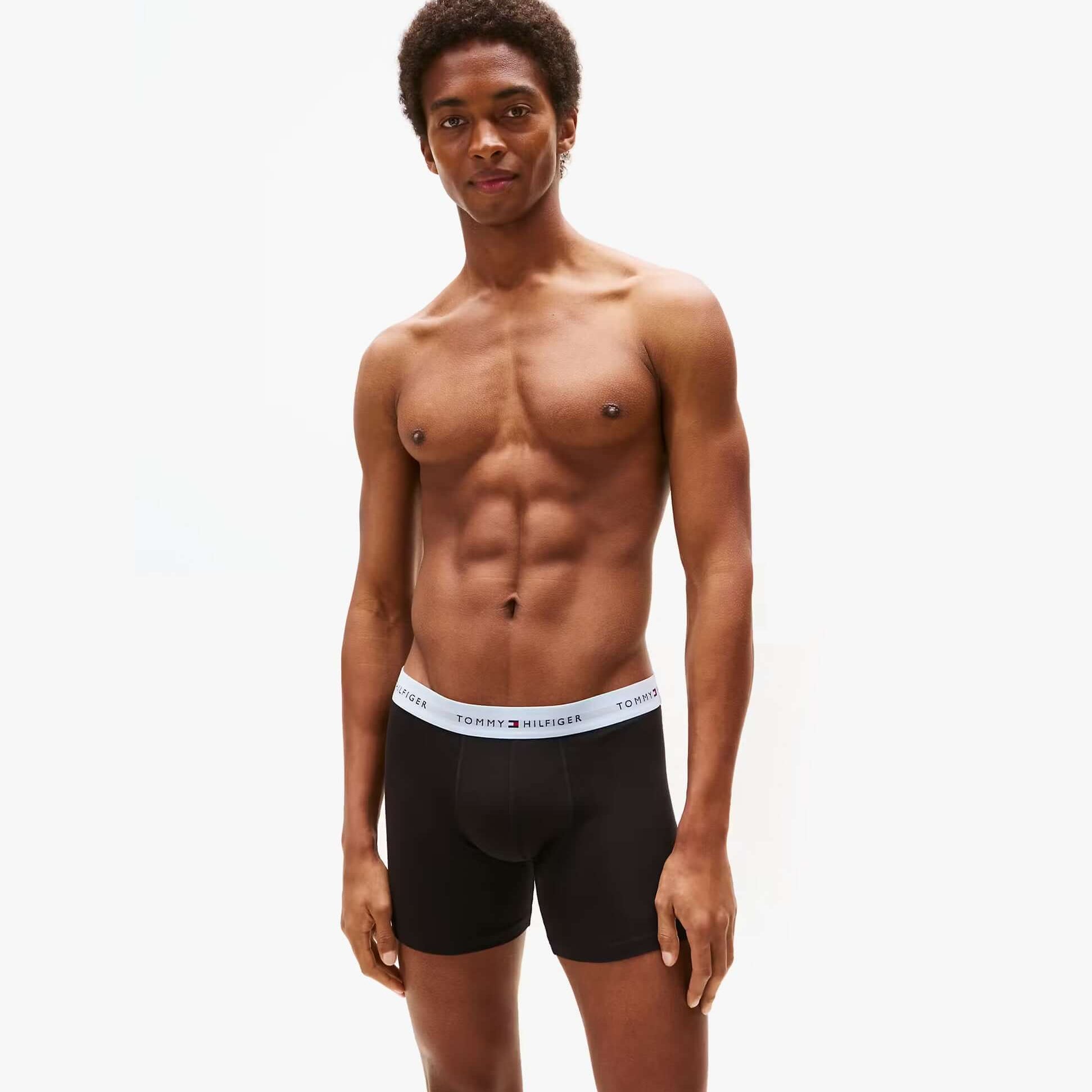 Tommy Hilfiger BOXER BRIEF 3 Pack Mens Cotton Stretch Black front view model wearing briefs with visible logo waistband.