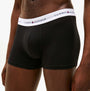 Tommy Hilfiger Mens 3 Pack Trunks Black side view showcasing the soft cotton material and elastic waistband.