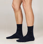 Tommy Hilfiger ORIGINAL Mens Trunk & Sock Gift Set Navy featuring navy socks on model's feet, side view.