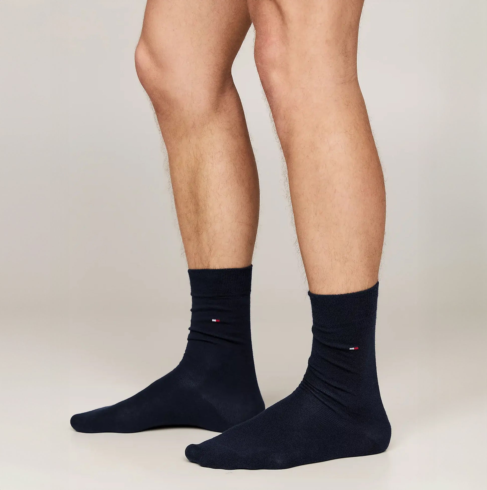 Tommy Hilfiger ORIGINAL Mens Trunk & Sock Gift Set Navy featuring navy socks on model's feet, side view.