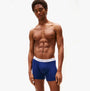 Tommy Hilfiger Mens 3 Pack Logo Waistband Boxer Briefs Multi side view model wearing navy blue boxer briefs with logo waistband.