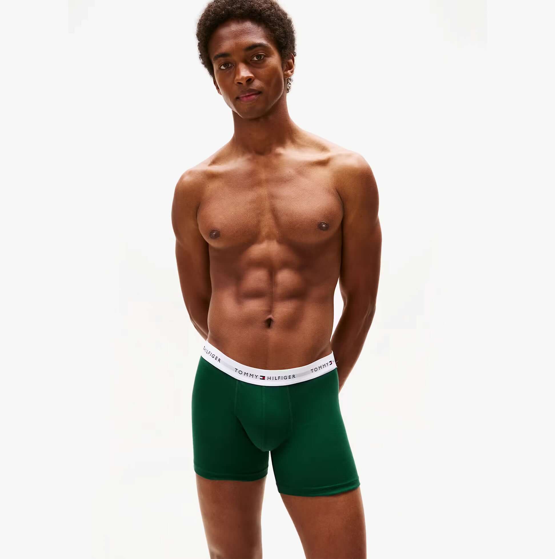 Tommy Hilfiger Mens 3 Pack Logo Waistband Boxer Briefs Multi front view on model wearing dark green boxer briefs.