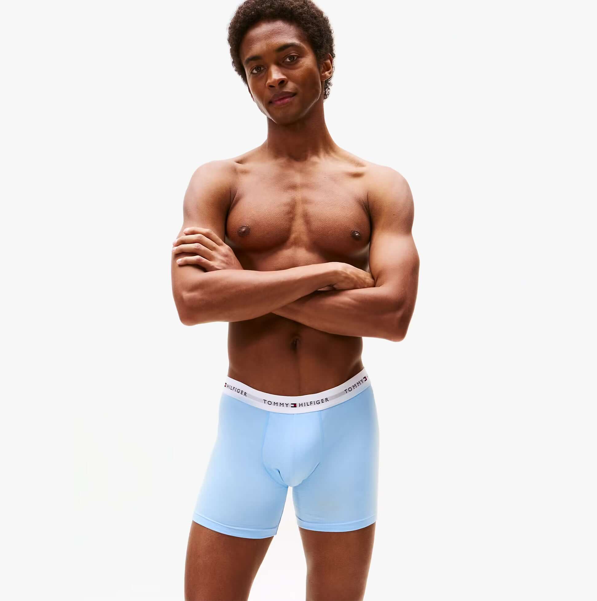 Tommy Hilfiger Mens 3 Pack Logo Waistband Boxer Briefs Multi front view on model wearing light blue underwear.