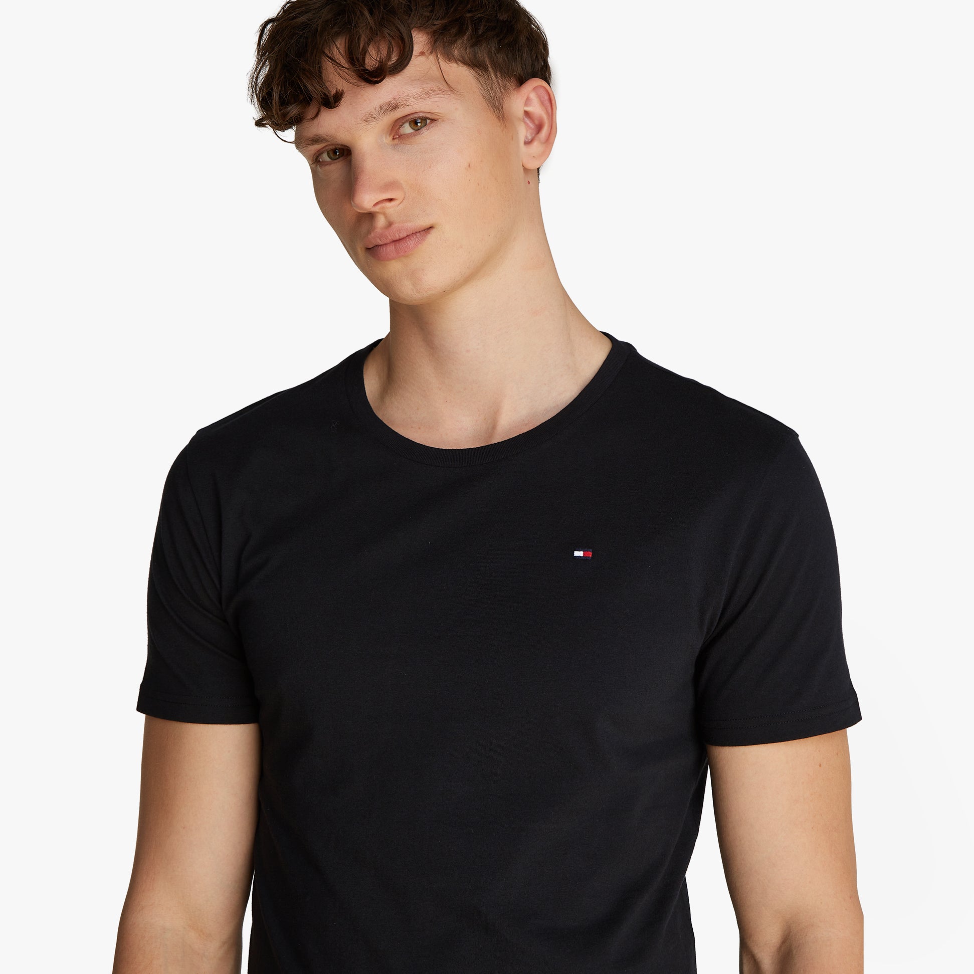 Tommy Hilfiger PURE COTTON Mens 3 Pack T-Shirts Black, front view, model wearing short sleeve crew neck shirt with TH flag embroidery.