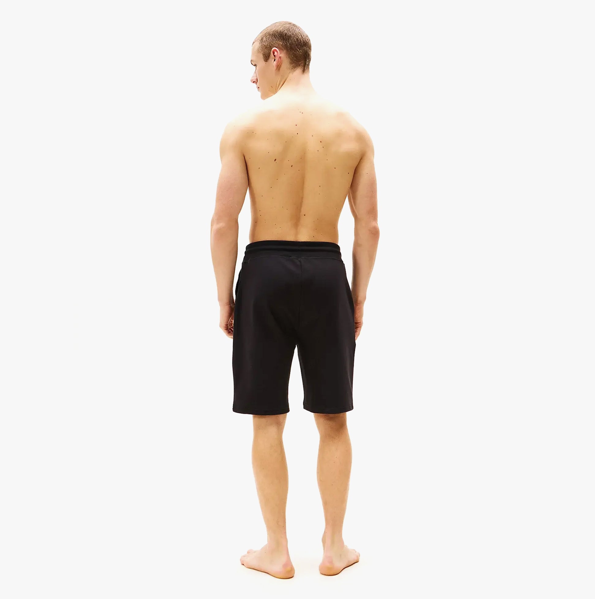 Tommy Hilfiger Mens Lounge Shorts Black back view on model, showcasing regular fit and black color.
