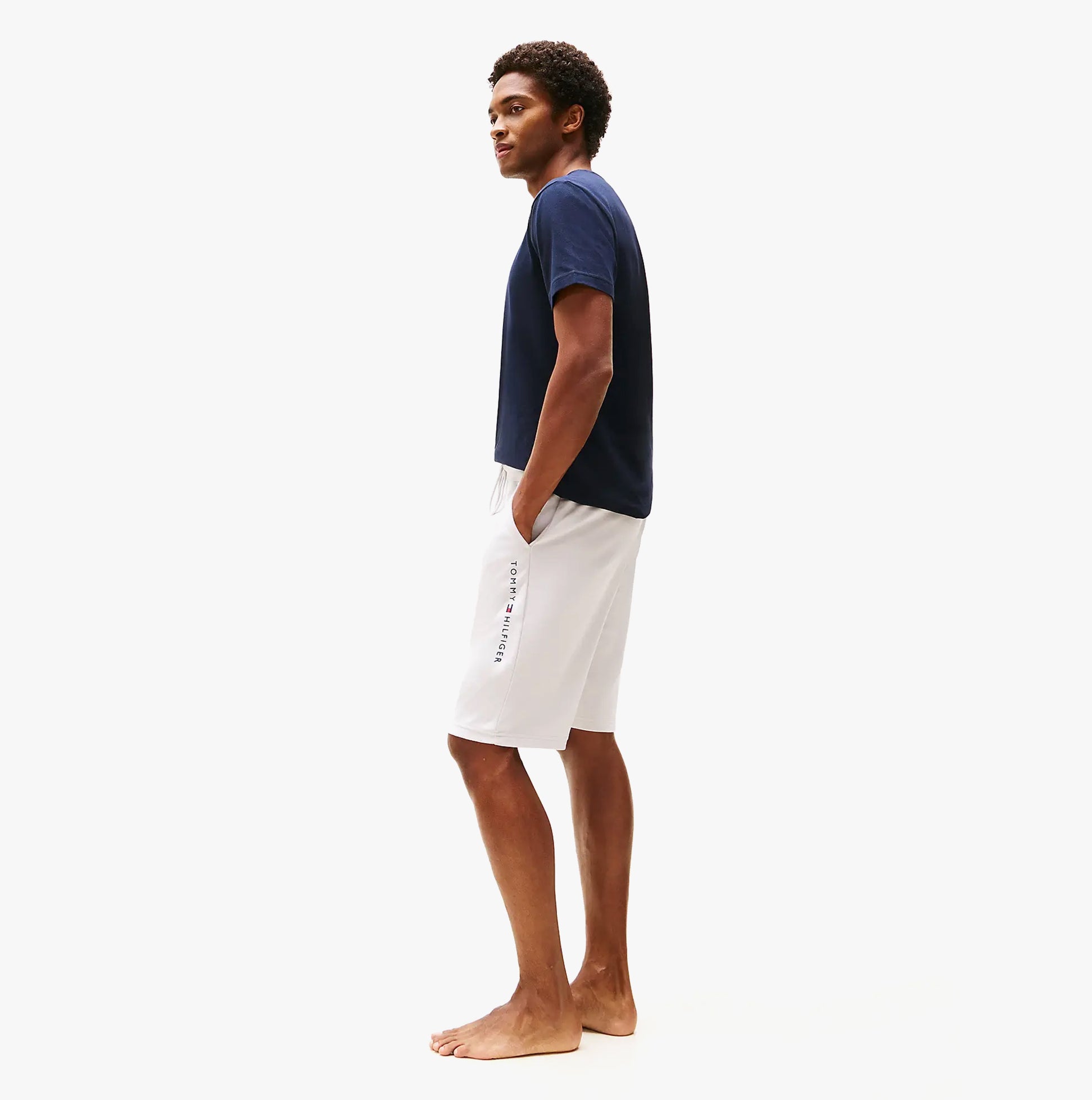 Tommy Hilfiger Mens Lounge Shorts Beige side view worn by model, featuring elastic waistband and relaxed fit.