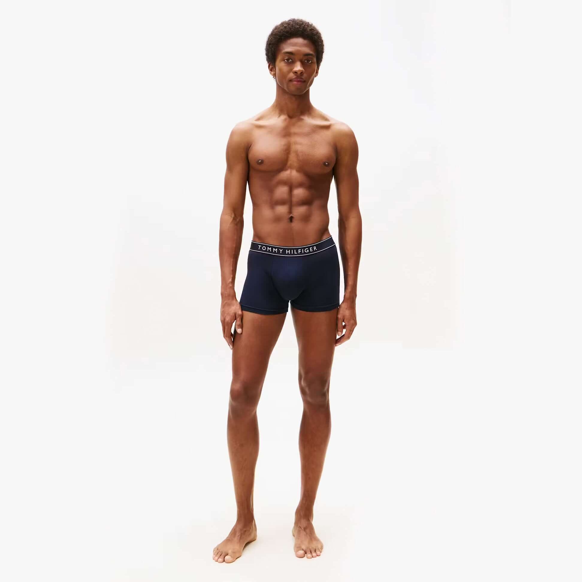 Tommy Hilfiger Mens 3 Pack Logo Waistband Trunks Multi front view on model wearing navy trunks with logo waistband.