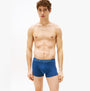 Tommy Hilfiger 3 Pack Mens Trunks Des Sky/Calico/Fssl Blue front view on model, showcasing stretch cotton fabric and logo waistband.