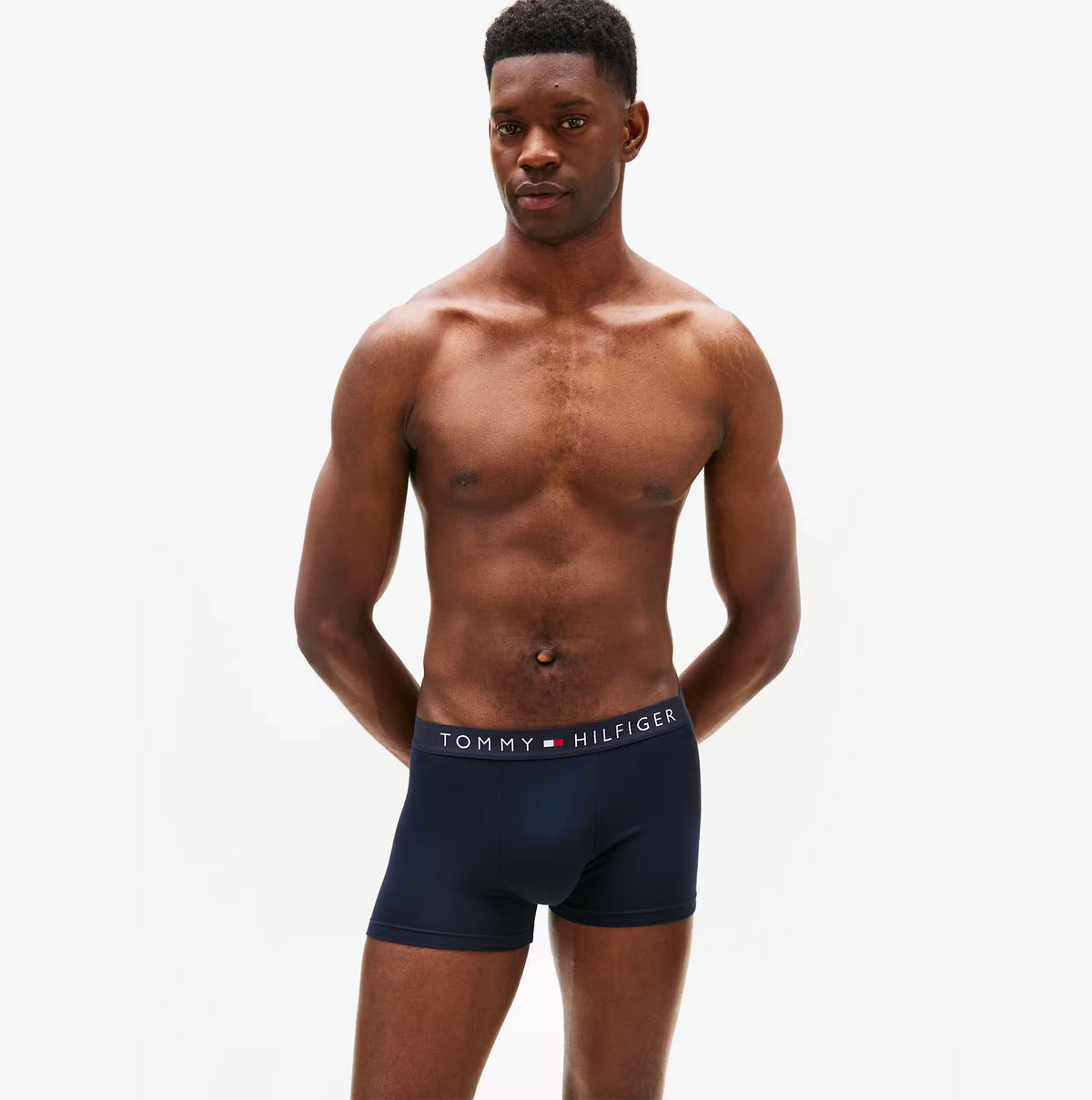 Tommy Hilfiger 3 PACK Mens Trunks Multicoloured front view on model wearing navy trunk with logo waistband.