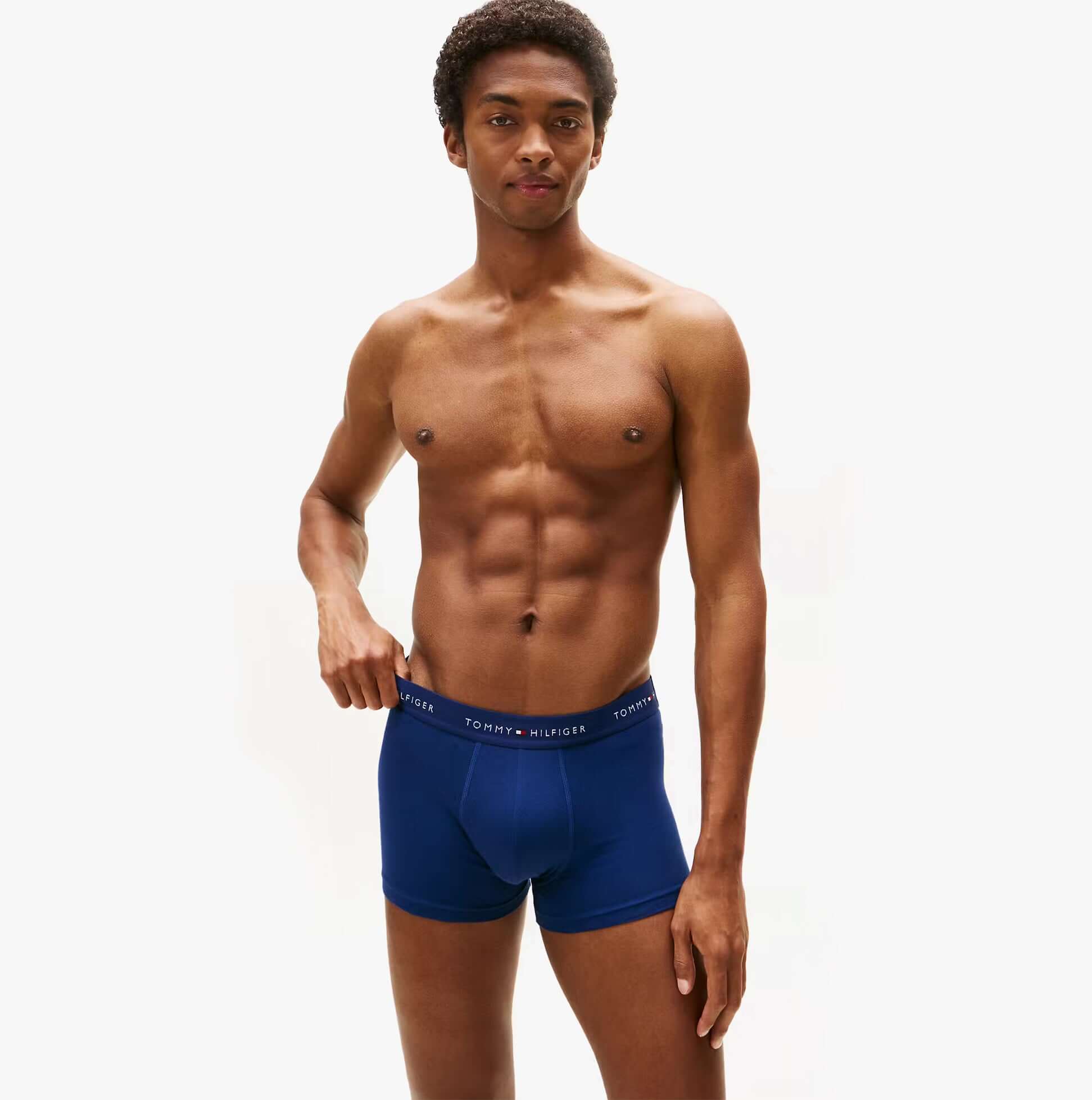 Tommy Hilfiger Mens 3 Pack Logo Waistband Cotton Trunks Multi side view on a model wearing navy blue trunks