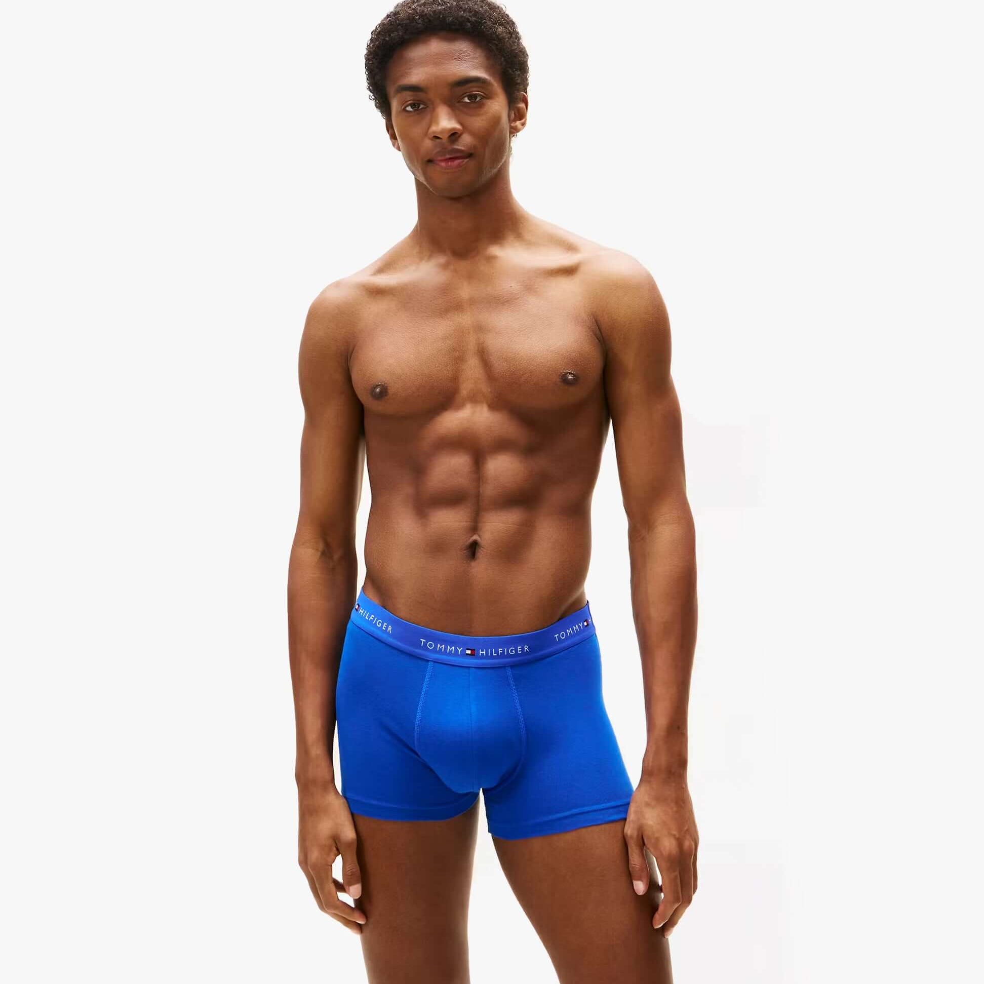 Tommy Hilfiger Mens 3 Pack Logo Waistband Cotton Trunks Multi front view in blue color with logo waistband, model displaying fit.
