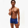 Tommy Hilfiger 3-Pack Signature Mens Microfibre Trunks Multicoloured model side view wearing navy trunks.
