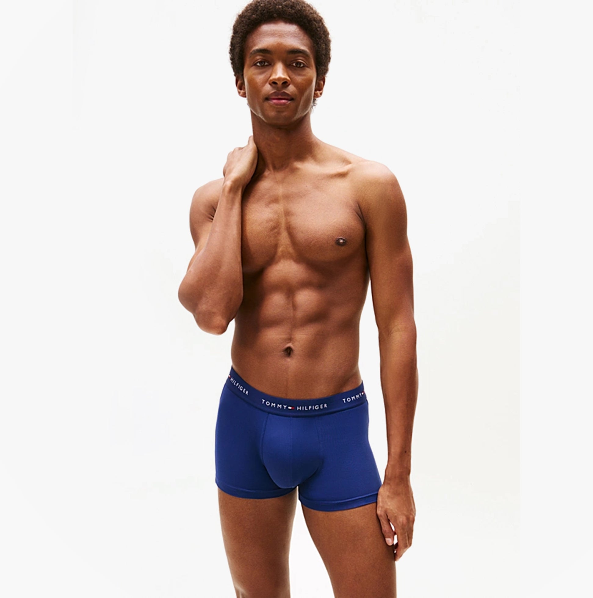 Tommy Hilfiger 3-Pack Signature Mens Microfibre Trunks Multicoloured model side view wearing navy trunks.
