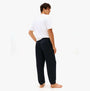 Tommy Hilfiger TRACK PANT Mens Desert Sky back view on model wearing a white shirt, showcasing comfort and style.