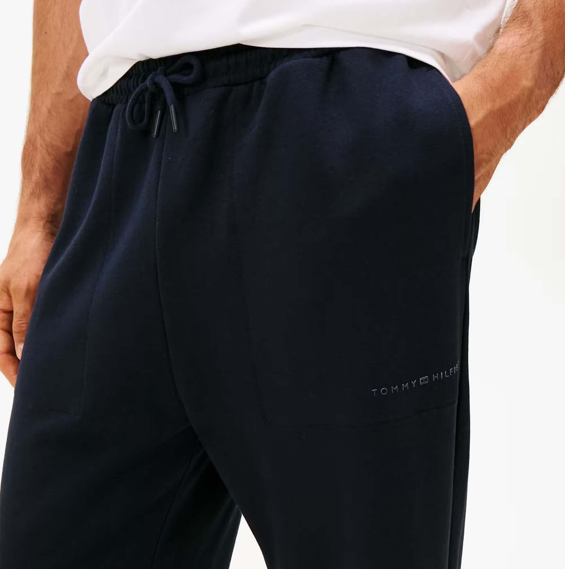 Tommy Hilfiger TRACK PANT Mens Desert Sky detail view with logo and pockets, showcasing fabric and color.