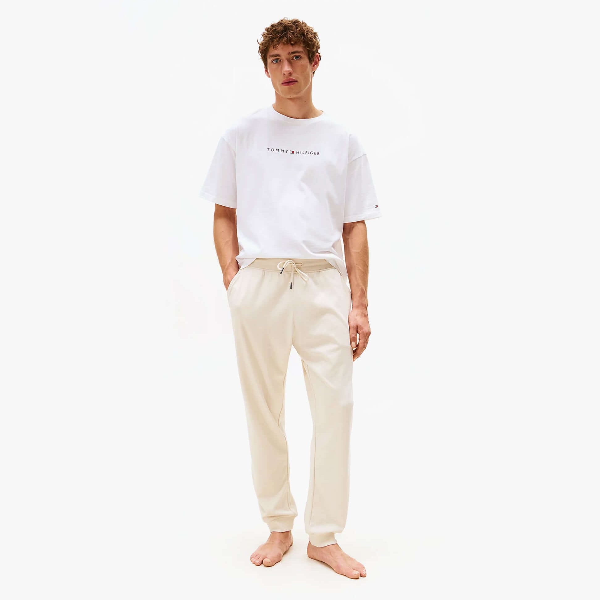 Tommy Hilfiger TH Original Mens Logo Lounge Joggers Off White Newsprint front view, stylish design, comfortable fit.