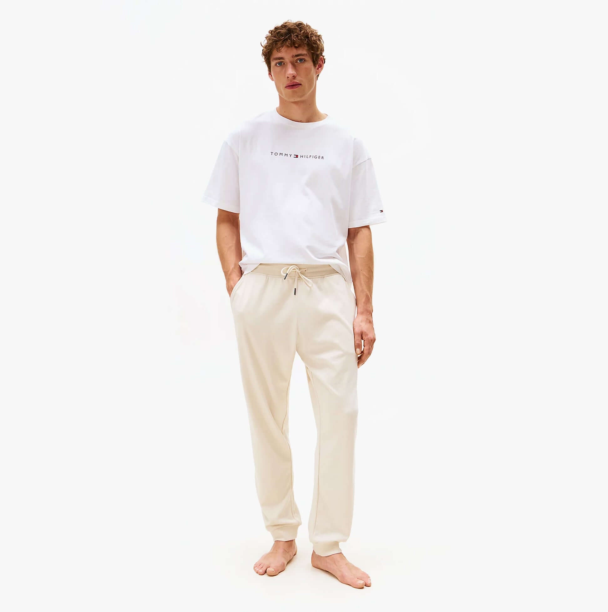 Tommy Hilfiger TH Original Mens Logo Lounge Joggers Off White Newsprint front view, stylish design, comfortable fit.