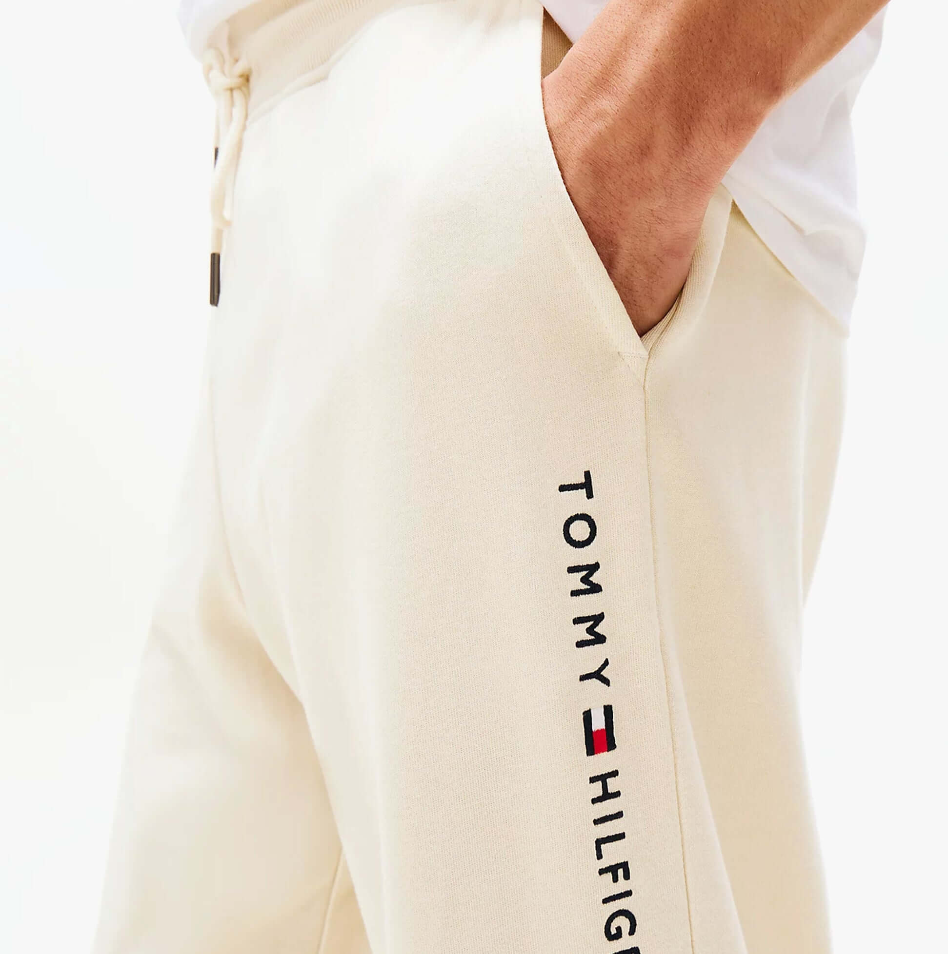 Tommy Hilfiger TH Original Mens Logo Lounge Joggers Off White Newsprint detail view of joggers showing logo and pocket.