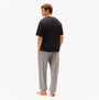 Tommy Hilfiger LOGO T-Shirt Mens Black back view worn with grey pants on model.