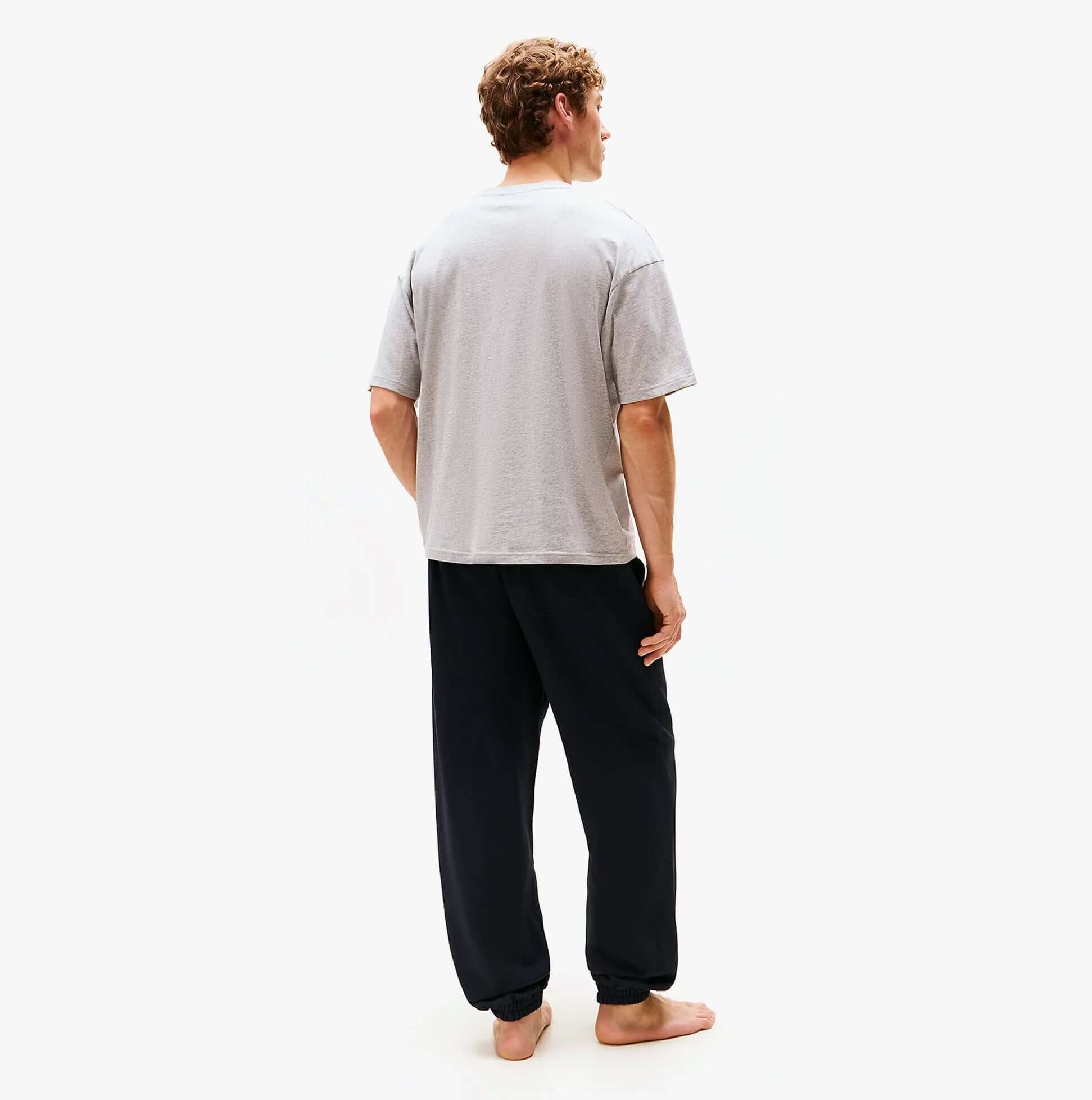 Tommy Hilfiger SS TEE CONT. LOGO Mens T-Shirts & Tank Tops Light Grey Heather back view on model wearing black pants.