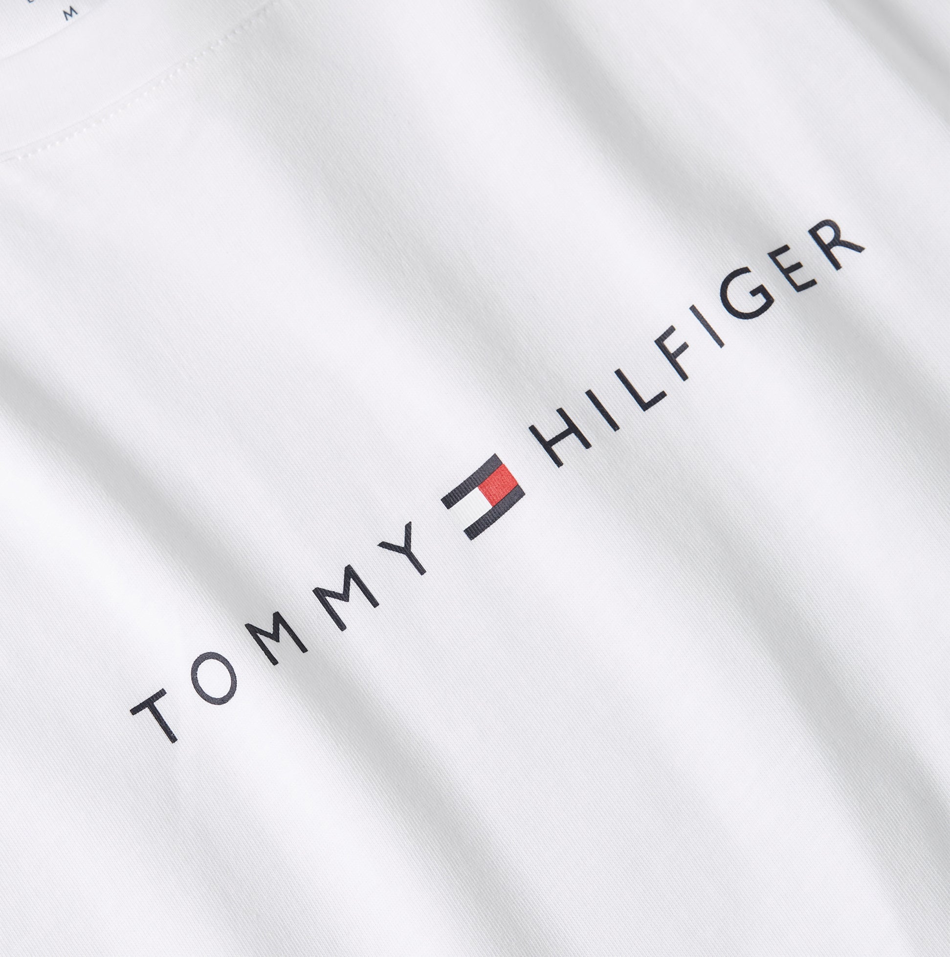 Tommy Hilfiger LOGO T-Shirt Mens Optic White detail view showcasing logo in black on white fabric.