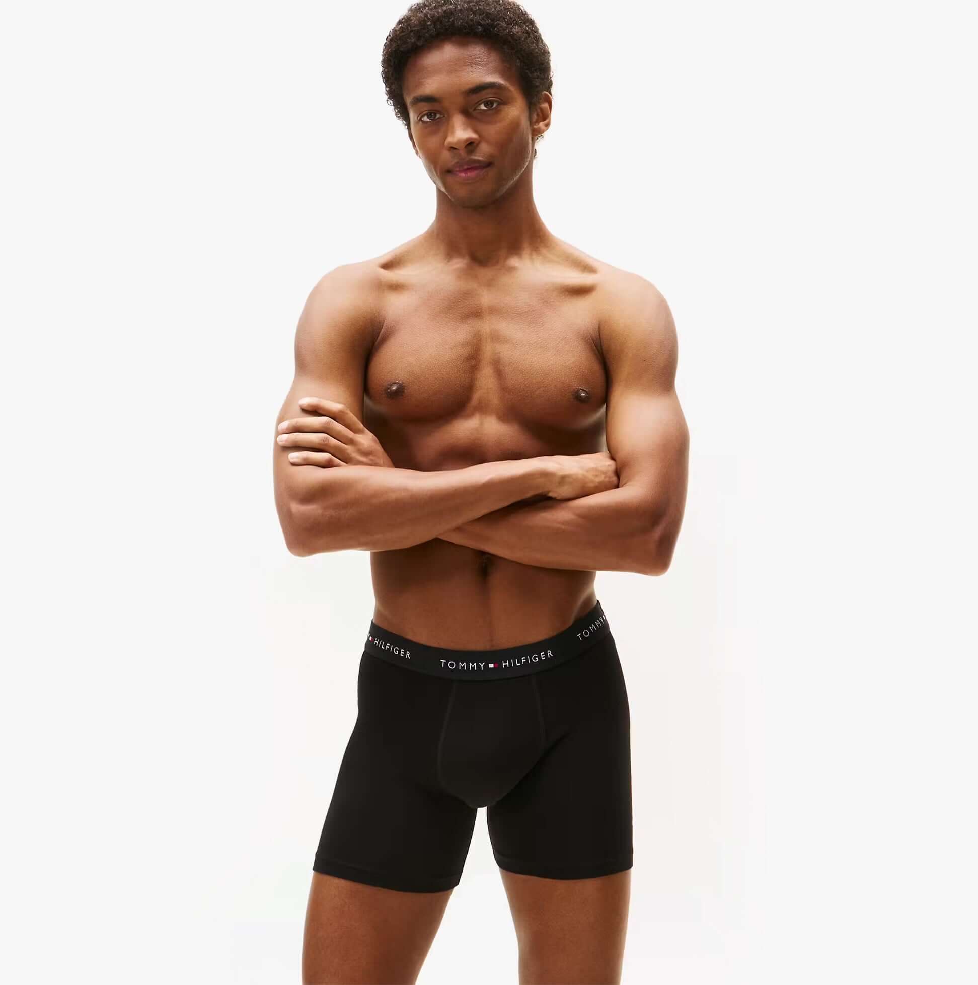 Tommy Hilfiger 3 Pack Mens BOXER BRIEF Multi front view model wearing black boxer briefs with logo waistband.