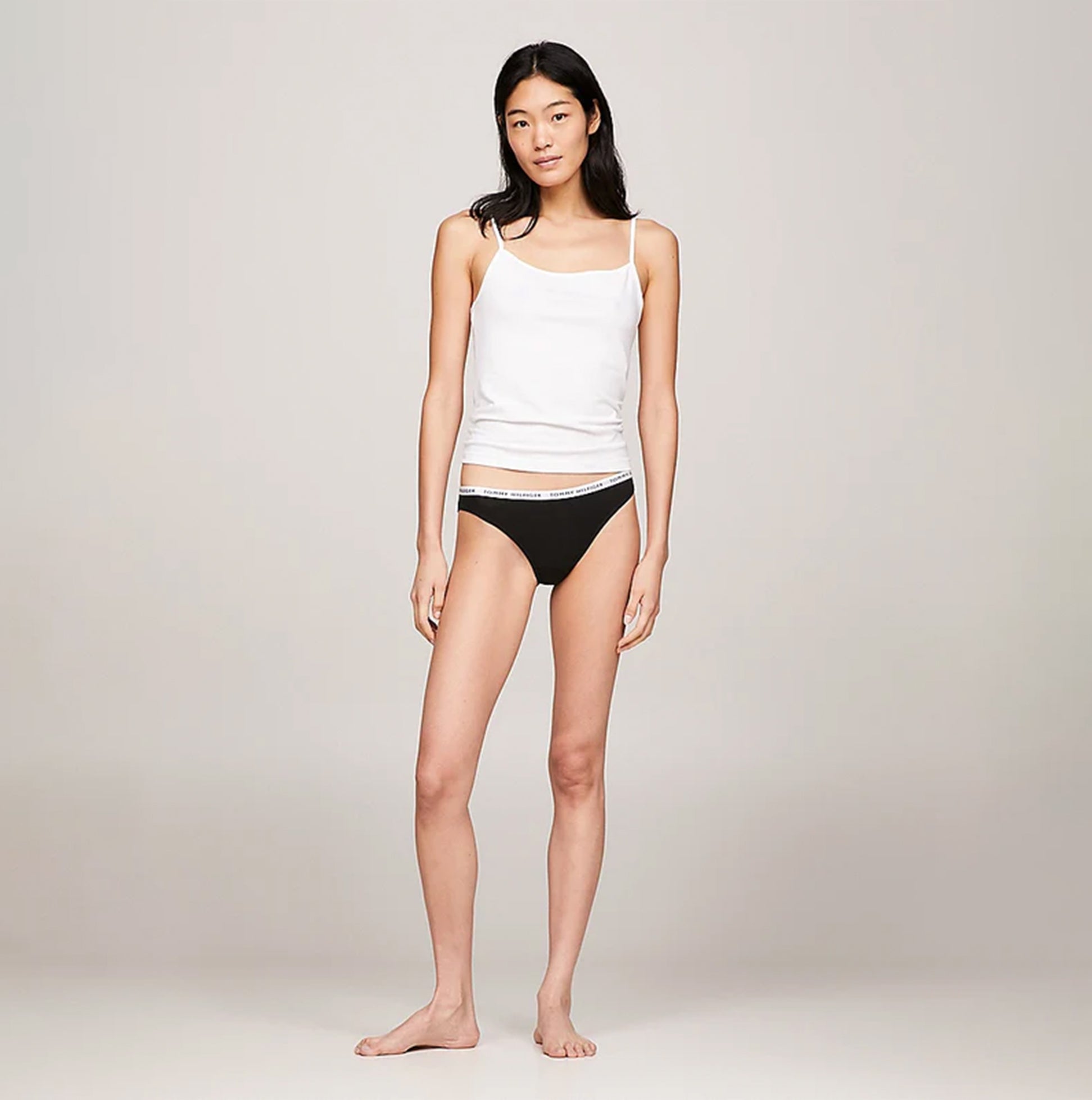Tommy Hilfiger BIKINI 3 Pack Womens Briefs Black on model, front view, styled with white tank top and showcasing elastic waistband.