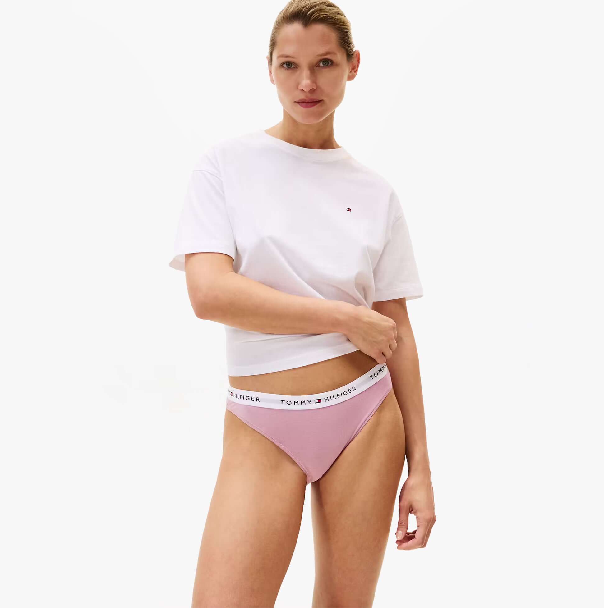 Tommy Hilfiger 3 Pack Womens BIKINI Multi showcasing front view of model wearing pink bikini underwear with white t-shirt.