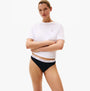 Tommy Hilfiger 3 Pack Womens BIKINI Multi model in front view wearing a white t-shirt and black bikini bottoms.