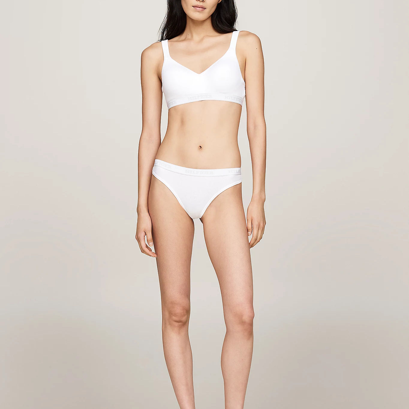Tommy Hilfiger MONOTYPE Womens Thong White front view worn by model, showcasing ribbed texture and elasticated waistband.