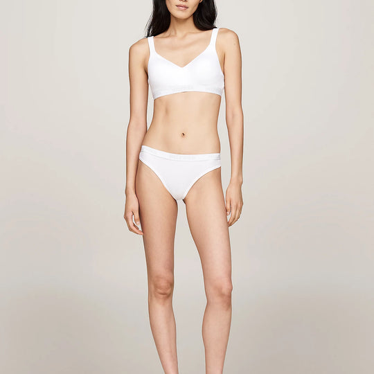 Tommy Hilfiger MONOTYPE Womens Thong White front view worn by model, showcasing ribbed texture and elasticated waistband.