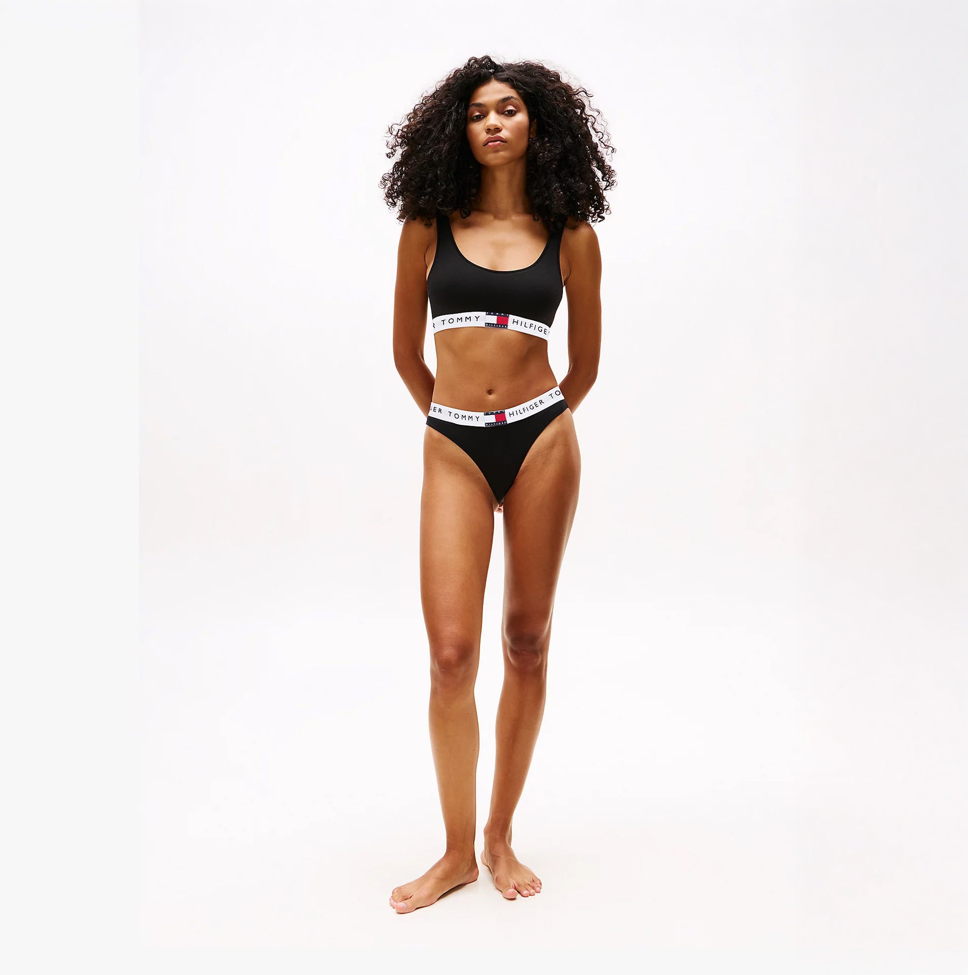 Tommy Hilfiger HERITAGE LOGO Womens Underband Non-Wired Bralette Black front view model wearing black bralette with logo underband