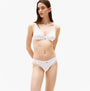 Tommy Hilfiger LACE TRIM Womens Dipped Thong White front view on model highlighting lace trim and dipped waist.