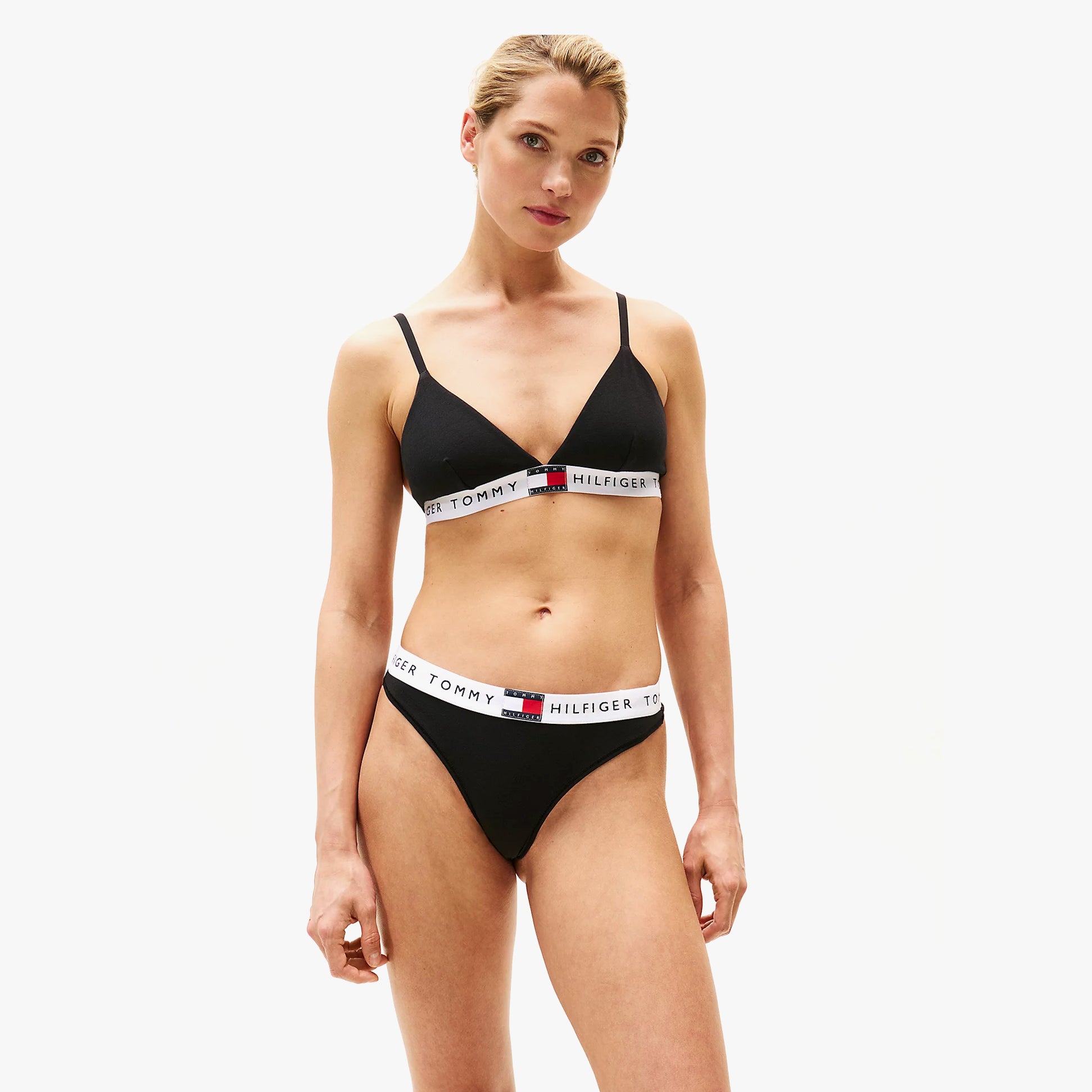 Tommy Hilfiger HERITAGE WAISTBAND Womens Logo Thong Black front view model wearing black thong and bralette.