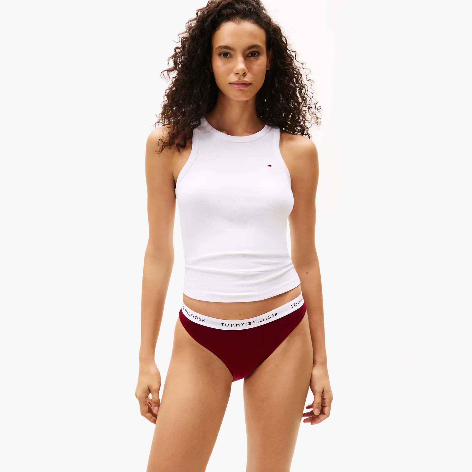 Tommy Hilfiger UW0UW06133 GIFT 3 PACK BIKINI P Womens Briefs Multicoloured model wearing red bikini briefs and white tank top, front view.