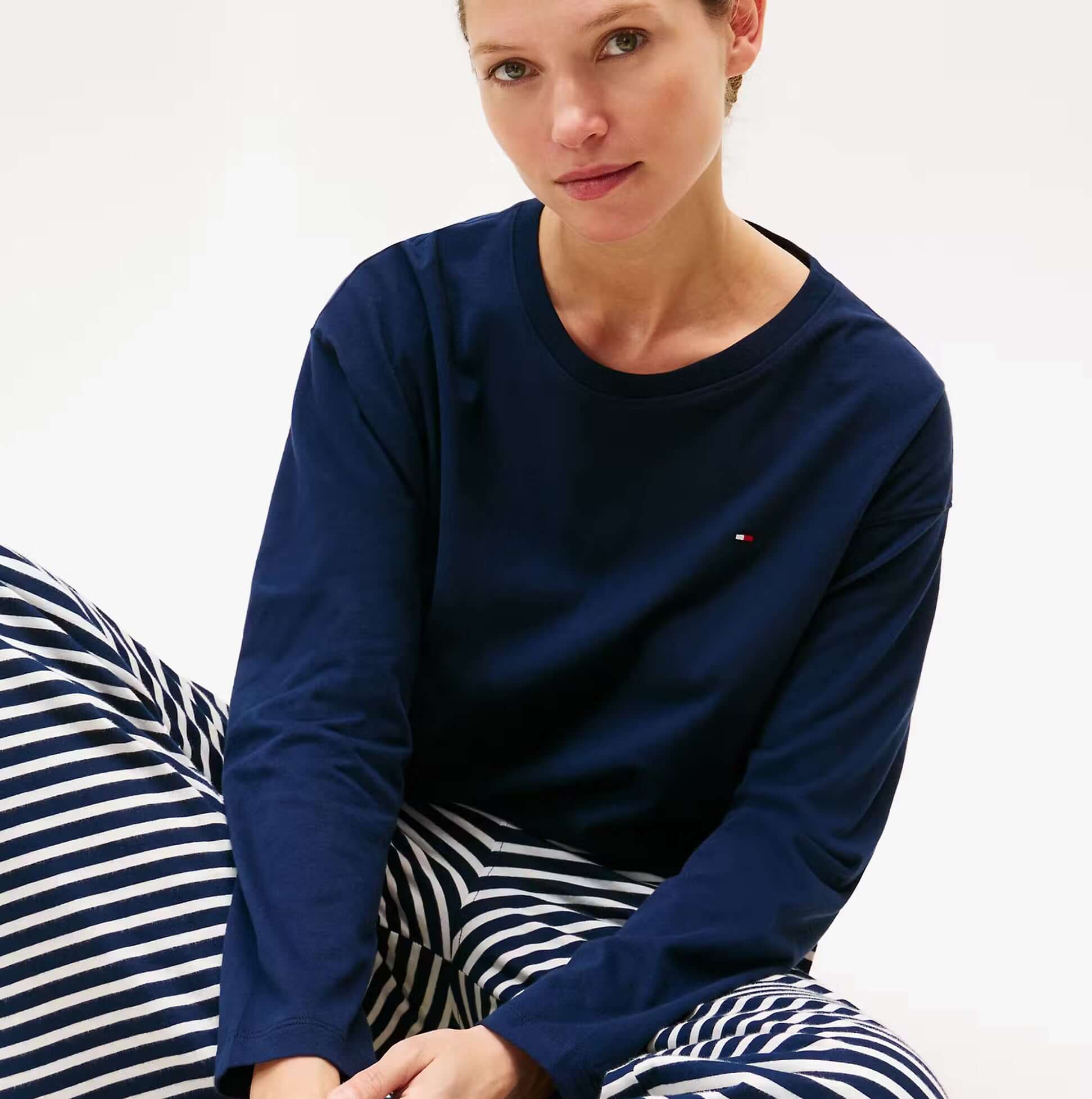Tommy Hilfiger LS JERSEY RELAXED PJ Womens Set Multicoloured front view featuring a model in navy top and striped pants.