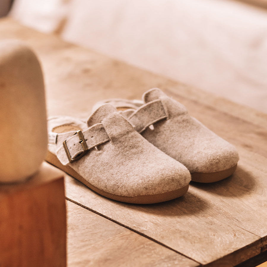Toni Pons MIMA-FP Womens Slippers Cru side view on wooden table highlighting felt upper and rubber sole