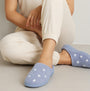 Totes Isotoner POPCORN TERRY Womens Mule Slippers Iris Blue Star side view on model's foot with cozy outfit